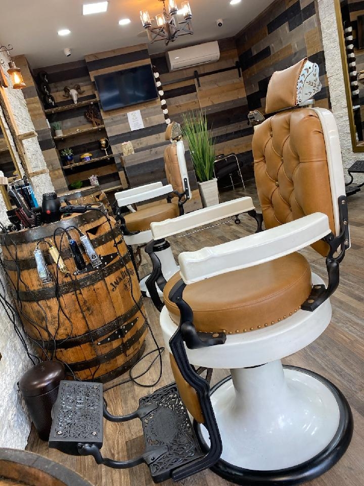 What are some popular hair treatments offered by East Village barbers for men's hair health?