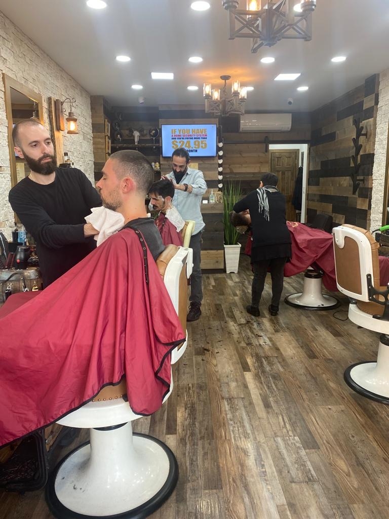 What role do Italian-American barbershops play in preserving cultural traditions within the community?